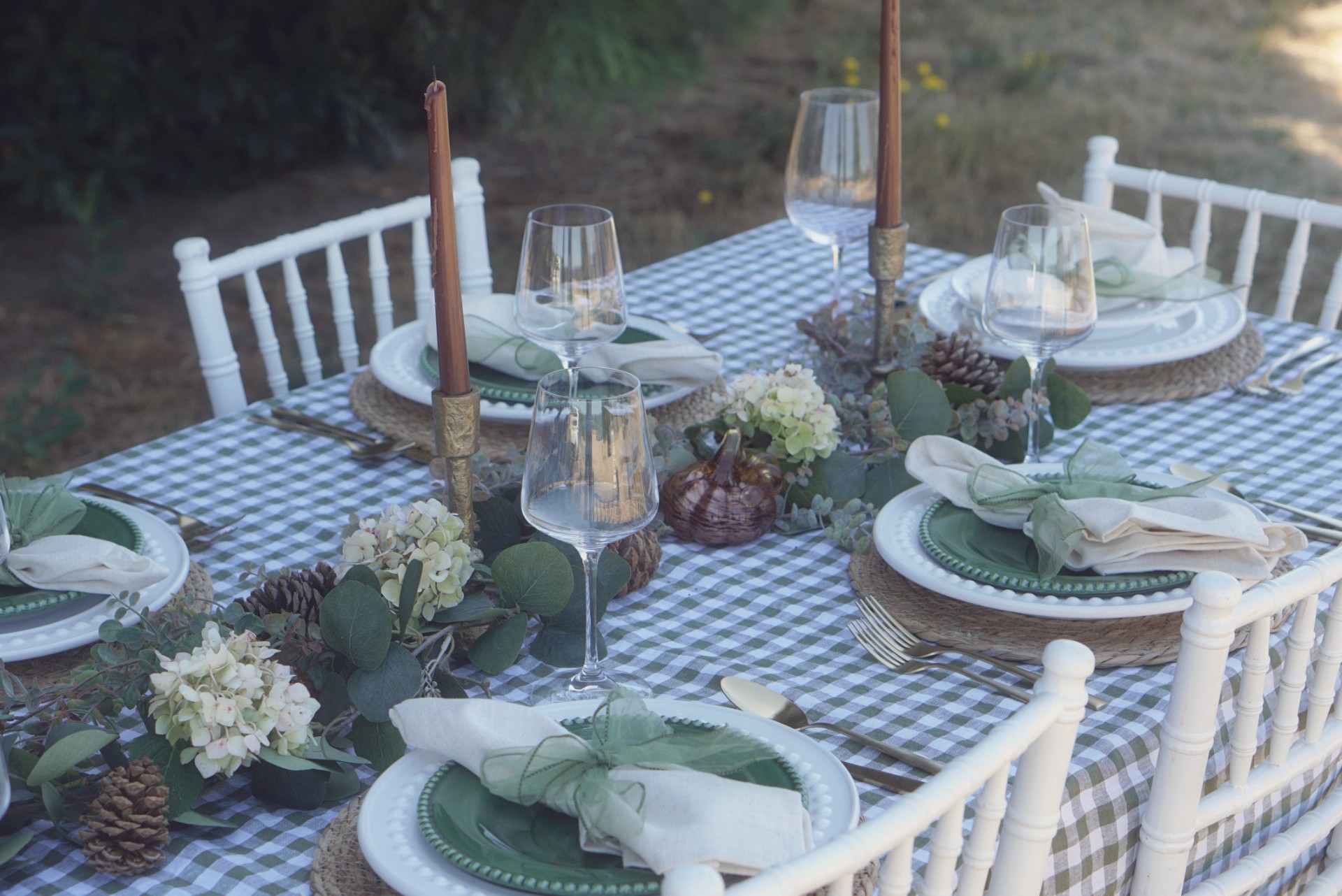 Green gingham tablescape with eucalyptus garland and amber glassware